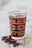 Hibiscus flower tea in an oriental tea glass