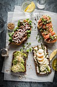 Three open sandwiches with various toppings