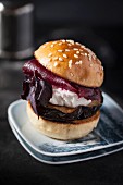 A mini burger with beetroot, aubergines and red basil