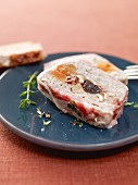 Dried fruit terrine wrapped in bacon