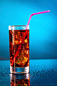 Glass of soda with a drinking straw