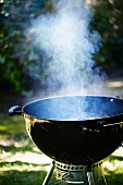 A smoking kettle barbecue