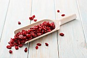 Dried cranberries on a wooden scoop