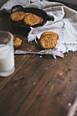Freshly baked cookies and milk on a wooden table