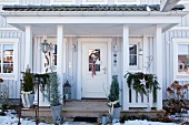 Festively decorated porch with wooden veranda in Scandinavian style