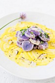 Yellow beetroot carpaccio with a purple potato salad
