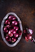 Red onions in a metal bowl