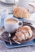 A sweet breakfast: croissants with icing and coffee