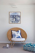 Elegant 'papas armchair' with seat cushion and cushion under a framed picture