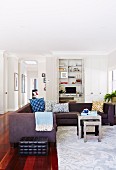 Corner sofa and coffee table set on light carpet with floral pattern in living room