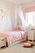 Romantic girl's room with canopy bed and pink duvet