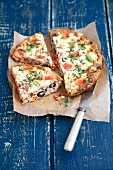 Oven-baked frittata with tomatoes, feta cheese, olives and peppers