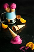 Melting berry sorbet in ice cream cones