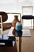Ceramic vase on black glossy side table