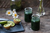 Green smoothies made with chlorella, spirulina, kiwi, limes and parsley