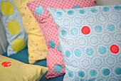 Cushion covers decorated with colourful spots of paint