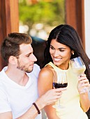 A couple on a terrace drinking wine