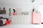 Pink and white furniture in open-plan interior