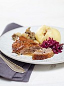 Goose with a chestnut stuffing served with red cabbage and dumplings