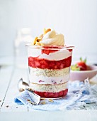 Homemade sponge cake in a glass with strawberry cream