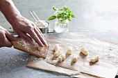 Homemade gnocchi: gnocchi being rolled on a board