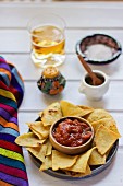 Totopos with a dip (Mexican snack)