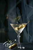 A martini vodka cocktail garnished with olives