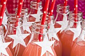 Fruit juice in glass bottles decorated with white stars