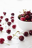 Cherries in a bowl and next to it