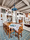 Rustic dining area with blue and white floor tiles in loft apartment