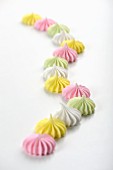 Colourful meringues on a white surface