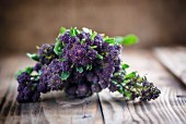 Purple sprouting broccoli on a wooden board