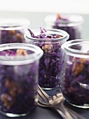Red cabbage salad with walnuts in jars