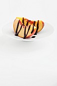 Peach slices drizzled with chocolate sauce
