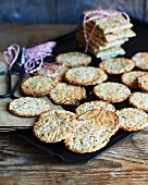 Round and square crispbreads with seeds on a baking tray