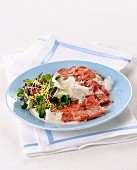 Tagliata di cotechino (raw sausage meat with shaved Parmesan, Italy)