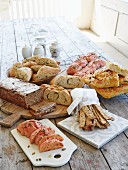 Various homemade breads and homemade pastries on a wooden table