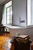 White, free-standing bathtub with wall-mounted taps in bathroom of 19th-century Italian villa