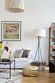 Oak parquet floor, gold pouffe and white loose-covered sofa in comfortable living area