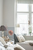 Cushions on white bench in corner of comfortable feminine bedroom