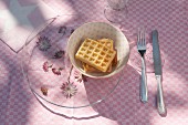 Astrantia under glass plate and waffles in bowl