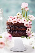 A spring chocolate cake made with beetroot decorated with buttercups