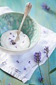 Coconut cream with lavender flowers in a ceramic bowl