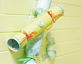 Hand-made pastel green and blue crackers tied with ribbons