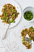 Two portions of oat salad with fava beans