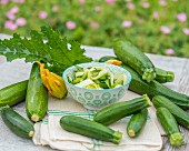 Courgettes and a courgette salad on a garden table