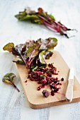 Beetroot with leaves sliced on a wooden board