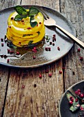 Sliced golden beet with dressing, mint and pink pepper