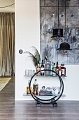 Arc Deco sideboard used as minibar below hat-shaped designer pendant lamp