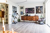 Arc Deco sideboard, retro wooden sideboard and armchair in open-plan living area